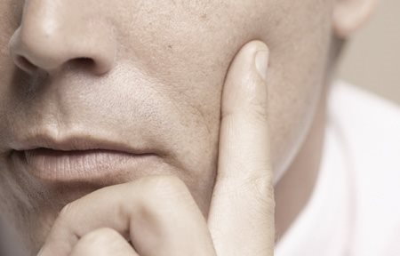 Dedo sobre la mejilla